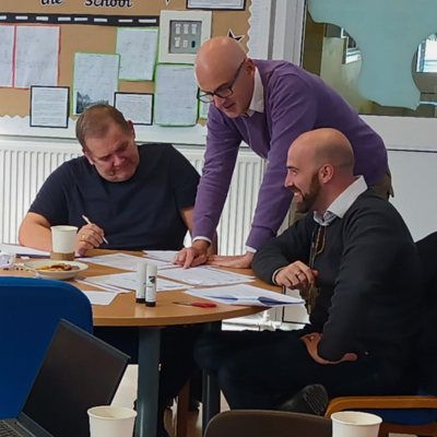 Three Governors having a conversation around a desk